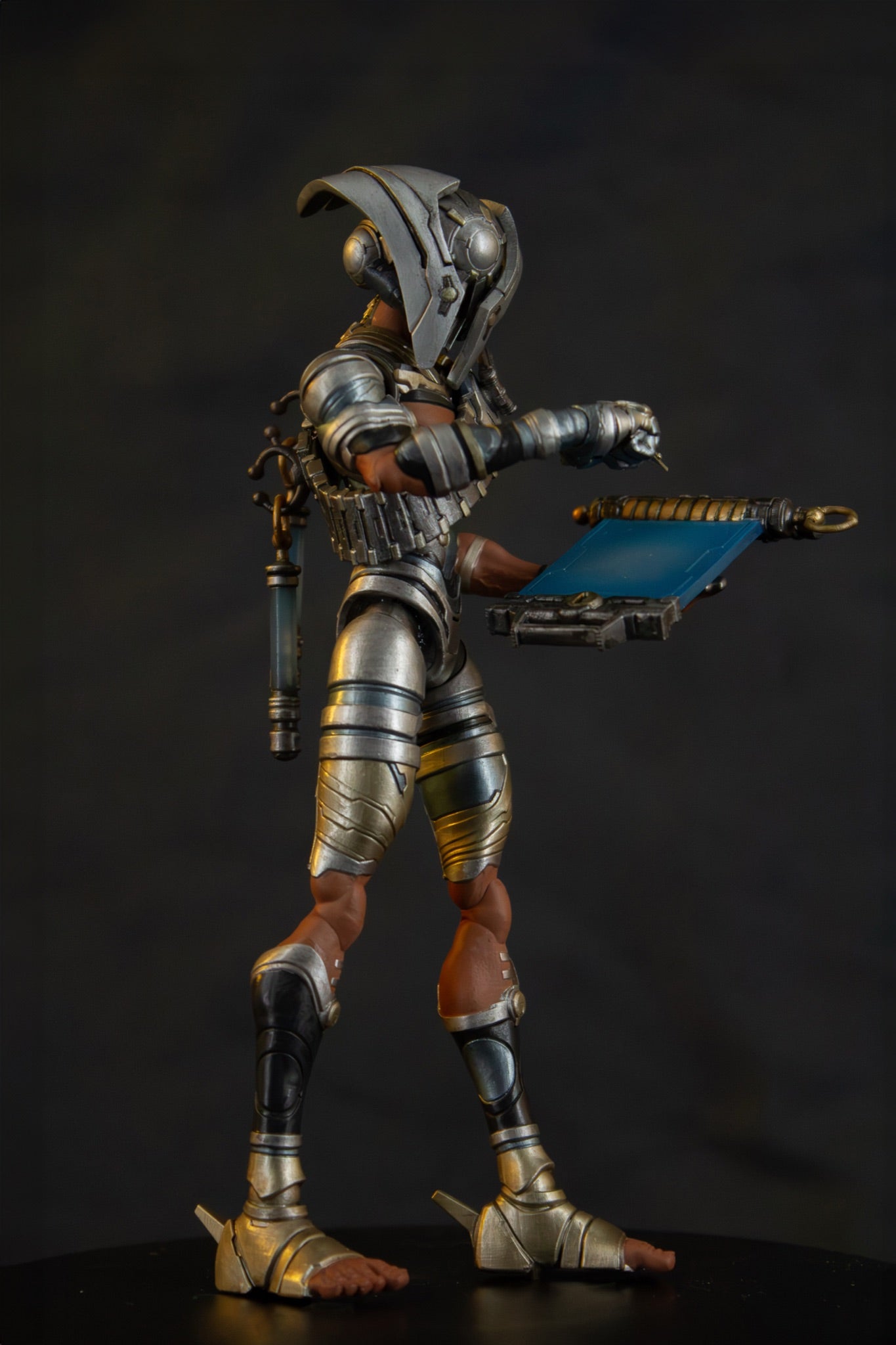 Enoch 7" action figure — back view, raised fist and weapon